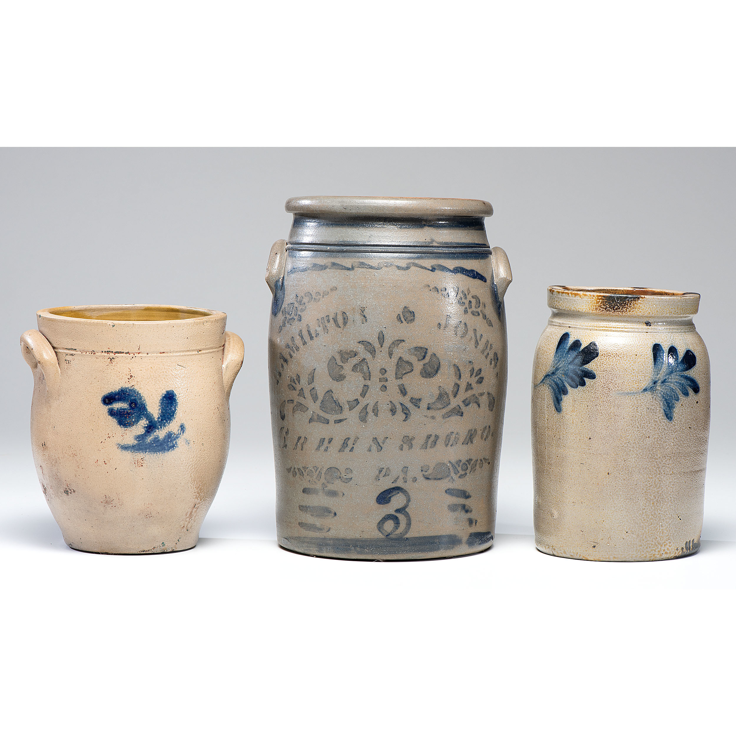 A Hamilton and Jones ThreeGallon Stoneware Crock and Two Other Crocks