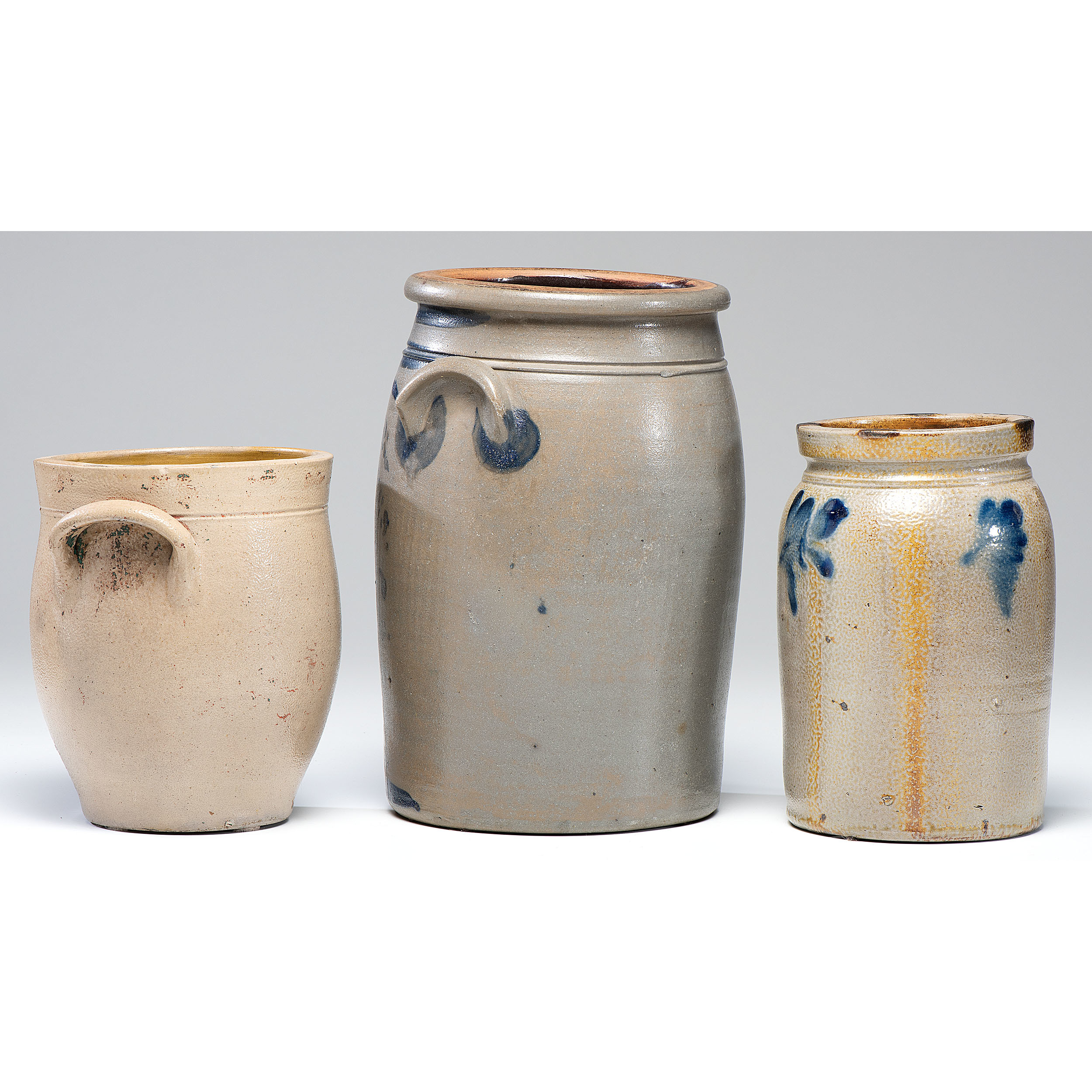 A Hamilton and Jones ThreeGallon Stoneware Crock and Two Other Crocks